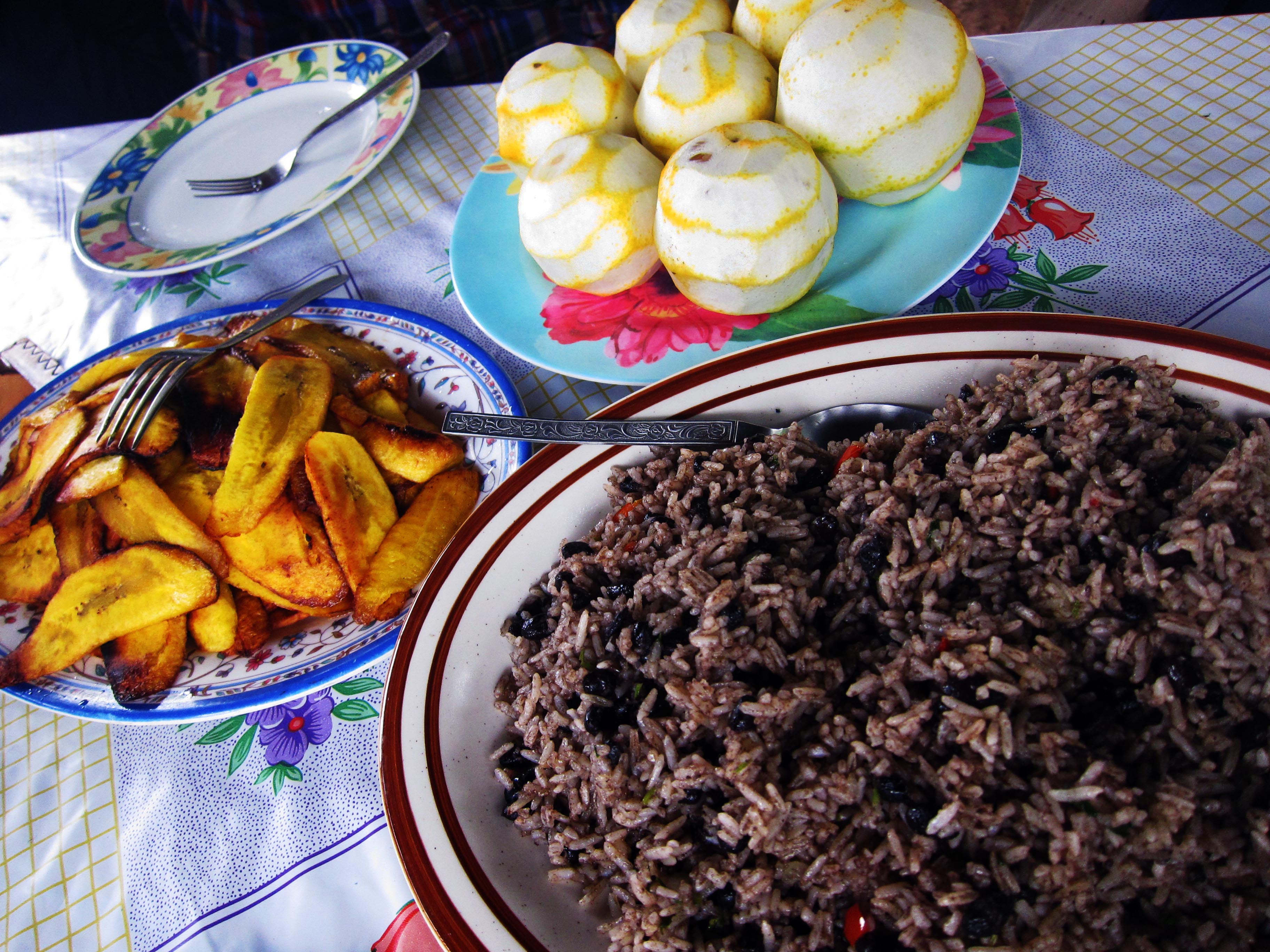 Breakfast sits on a table prepared in the traditional outdoor kitchen in Boruca. Rice and beans, fried plantains and oranges are all common foods at breakfast, as well as other daily meals.